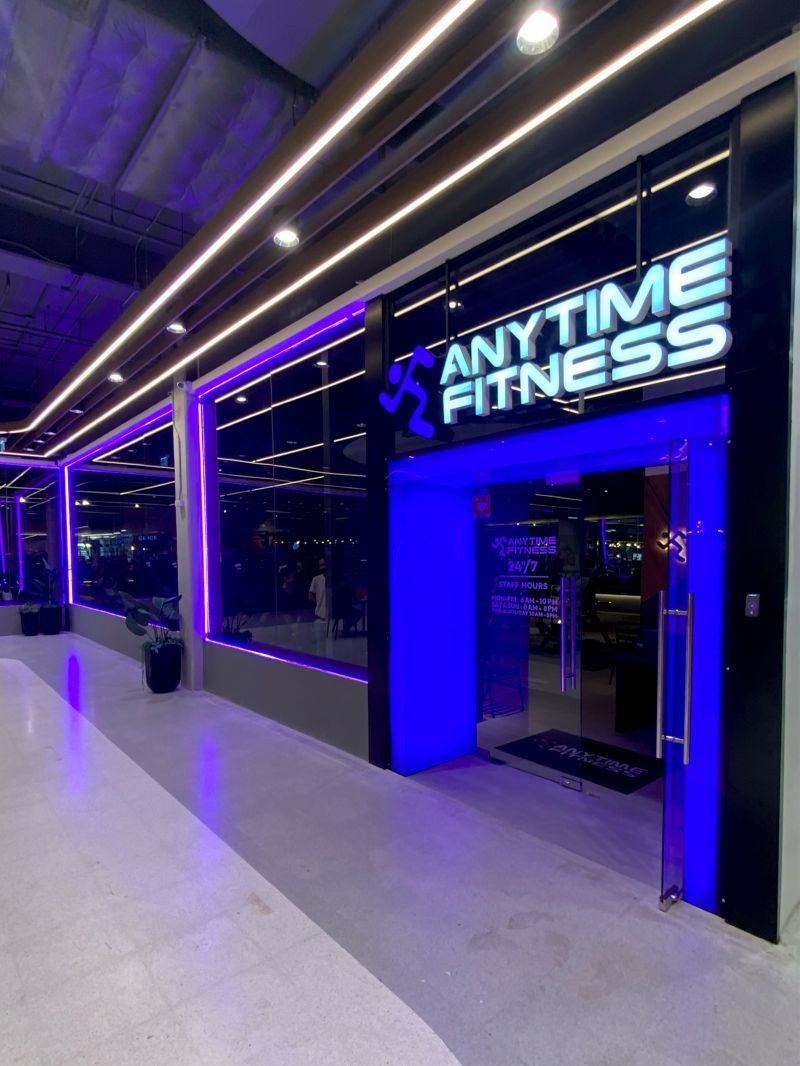 Illuminated Anytime Fitness sign at a club entrance